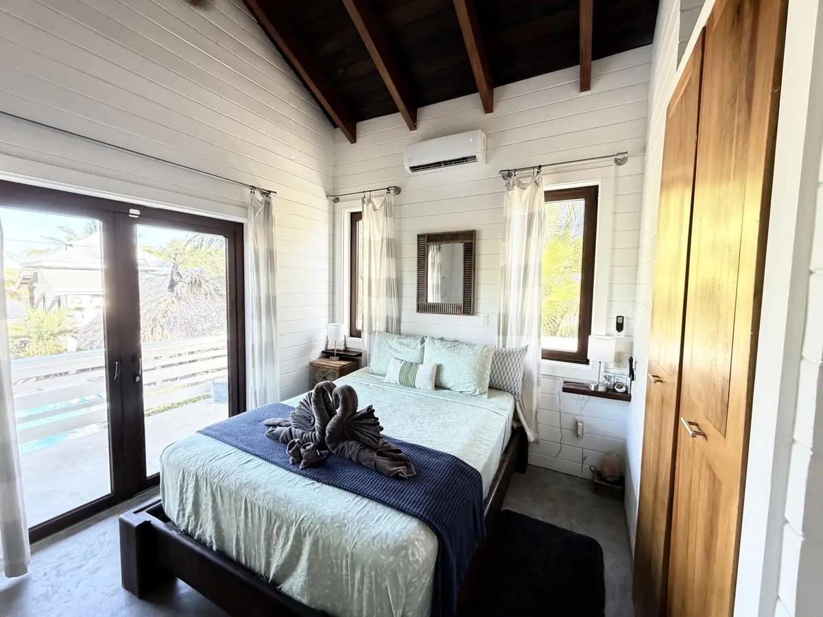 Casa guest bedroom with a bed facing the windows