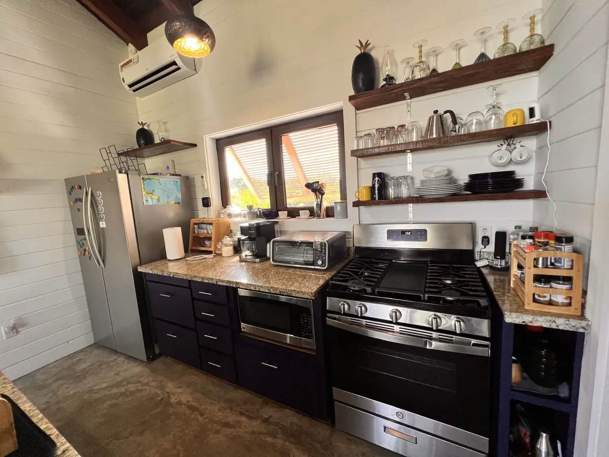 Casa kitchen with dark cabinets and a gas range