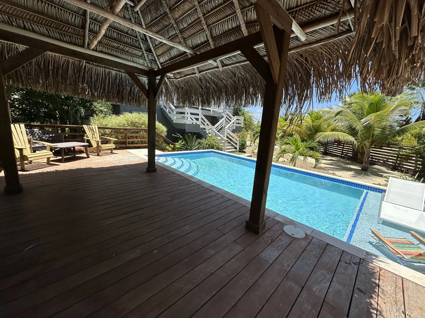 Thatched palapa and wooden deck beside Casa’s swimming pool