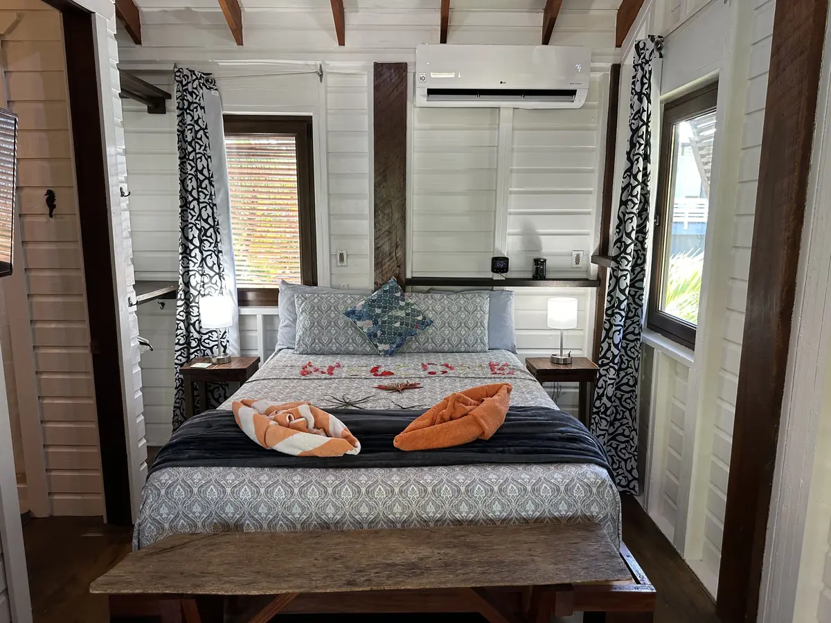 Casita bedroom with a queen bed and wood-paneled walls